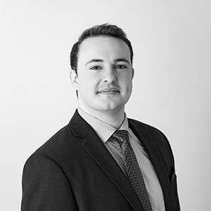 black and white photo of Ben Coleman in a black suite and tie